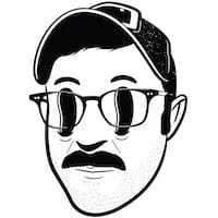 Retro 1920's animated head of Dann Berg, wearing a ball cap, with hollow eyes and a mustache